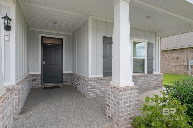 24884 Smarty Jones Cir, Daphne, AL 36526 - doorway to property with a porch, board and batten siding, and brick siding