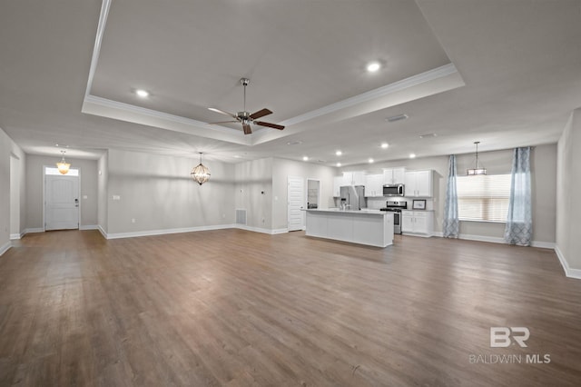 24884 Smarty Jones Cir, Daphne, AL 36526 - unfurnished living room with a raised ceiling, ceiling fan, dark wood-style floors, crown molding, and recessed lighting