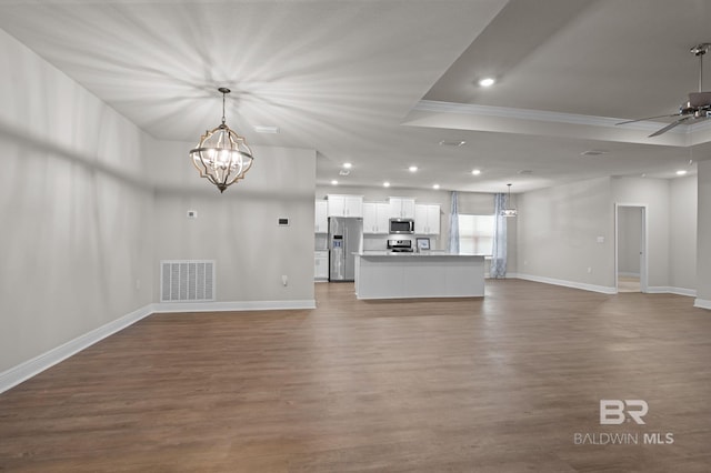 24884 Smarty Jones Cir, Daphne, AL 36526 - unfurnished living room with a chandelier, wood finished floors, recessed lighting, ornamental molding, and ceiling fan