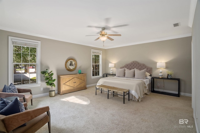 bedroom featuring light colored carpet, ceiling fan, and ornamental molding