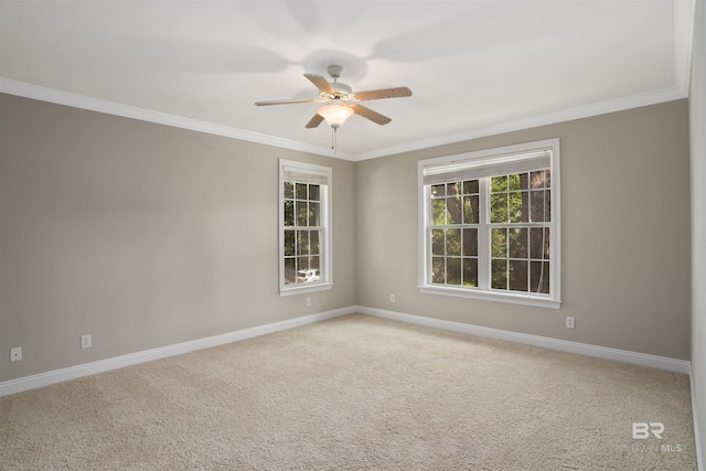 empty room featuring crown molding, ceiling fan, and light colored carpet