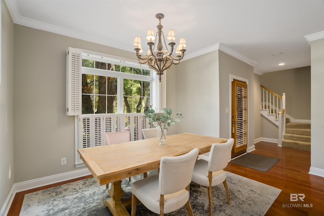 dining room featuring dark hardwood / wood-style flooring, crown molding, and a notable chandelier