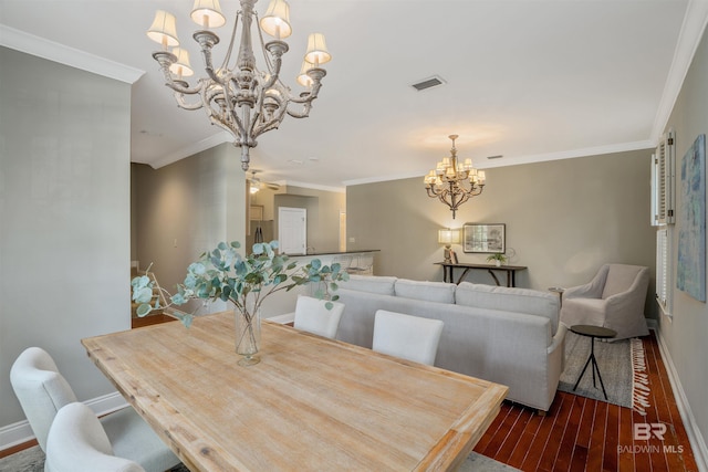 dining room featuring hardwood / wood-style floors, ceiling fan with notable chandelier, and ornamental molding