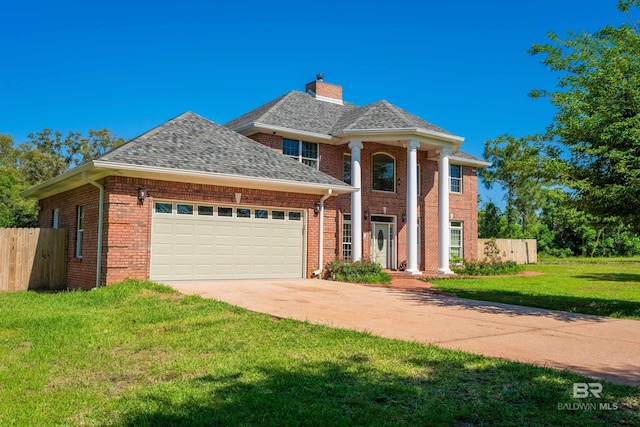 9150 County Road 91, Lillian, AL 36549 - neoclassical / greek revival house featuring an attached garage, concrete driveway, a chimney, brick siding, and roof with shingles