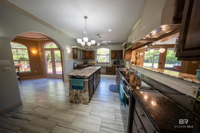 9150 County Road 91, Lillian, AL 36549 - kitchen with electric stove, arched walkways, ornamental molding, french doors, and baseboards