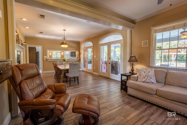 9150 County Road 91, Lillian, AL 36549 - living room featuring crown molding, french doors, wood finished floors, and baseboards