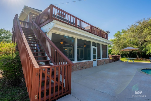 9150 County Road 91, Lillian, AL 36549 - back of house featuring stairs, a sunroom, a patio, an outdoor pool, and ceiling fan