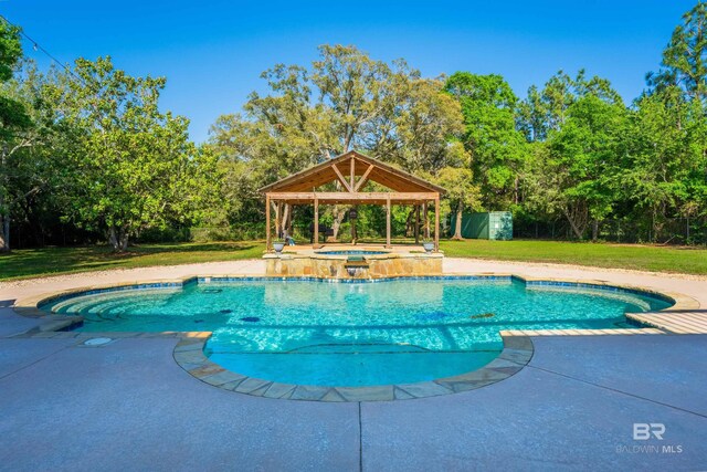 9150 County Road 91, Lillian, AL 36549 - swimming pool with a gazebo, an in-ground hot tub, a lawn, and view of wooded area