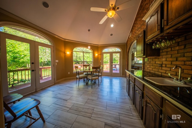 9150 County Road 91, Lillian, AL 36549 - dining space featuring french doors, baseboards, high vaulted ceiling, ceiling fan, and crown molding