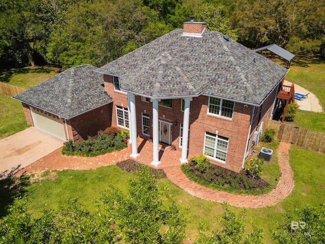 9150 County Road 91, Lillian, AL 36549 - view of front facade featuring a chimney, a garage, brick siding, central AC, and driveway