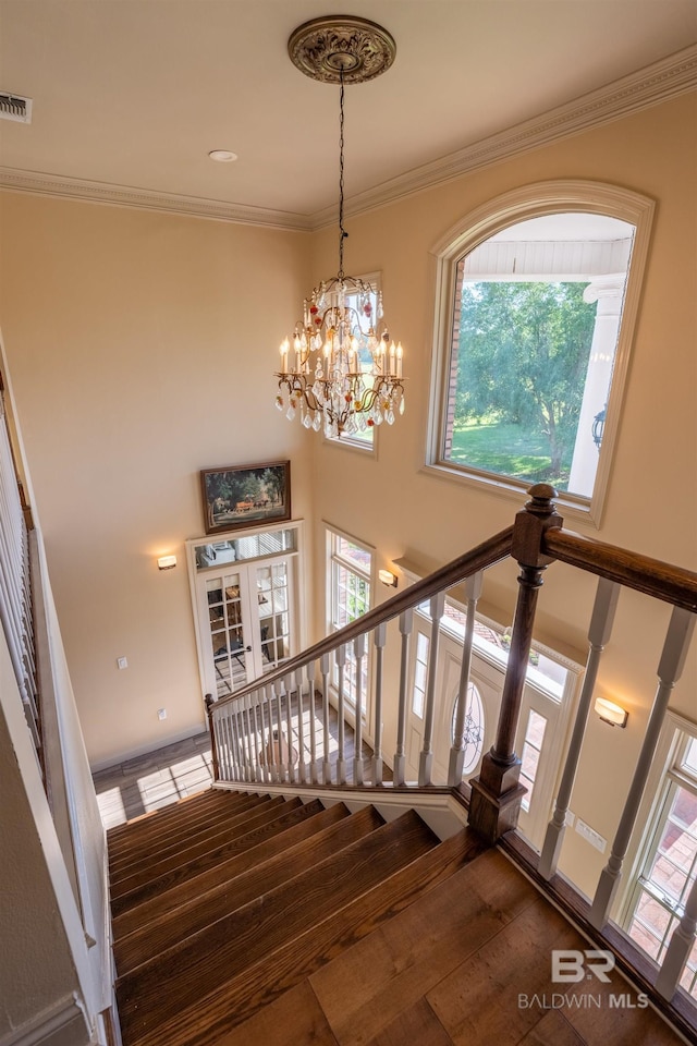 9150 County Road 91, Lillian, AL 36549 - staircase featuring a chandelier, crown molding, and a high ceiling