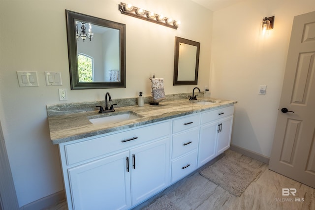 9150 County Road 91, Lillian, AL 36549 - full bath featuring double vanity, baseboards, and a chandelier