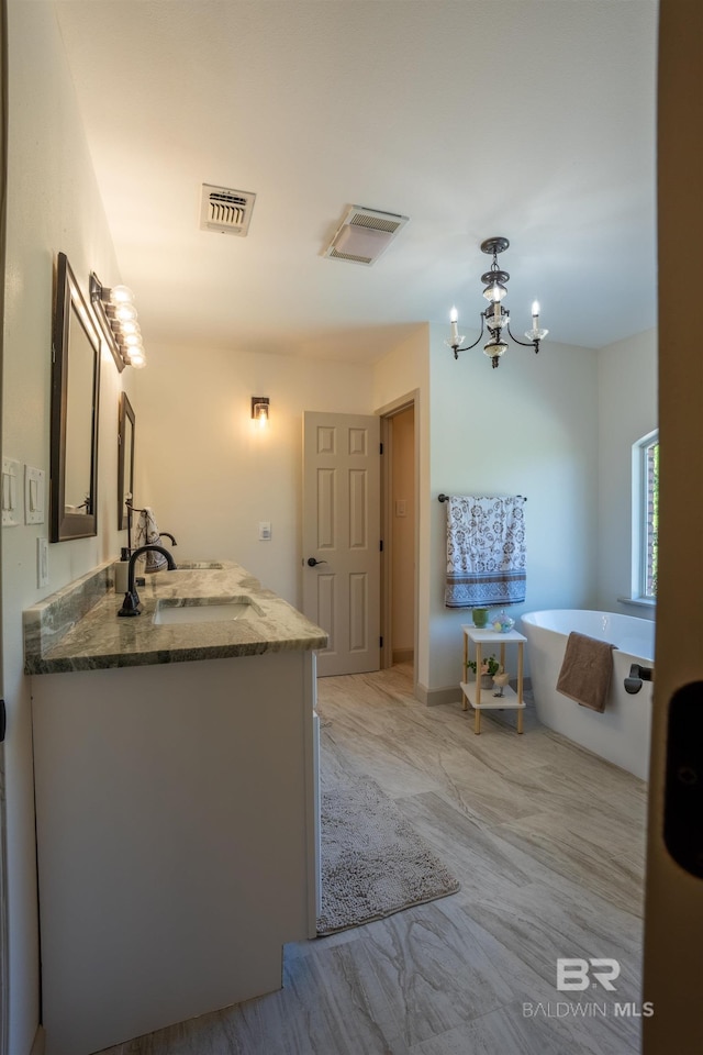9150 County Road 91, Lillian, AL 36549 - full bath with vanity, a freestanding tub, a chandelier, and baseboards