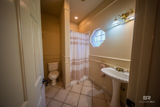 9150 County Road 91, Lillian, AL 36549 - full bath with toilet, tile patterned floors, a shower with curtain, and baseboards
