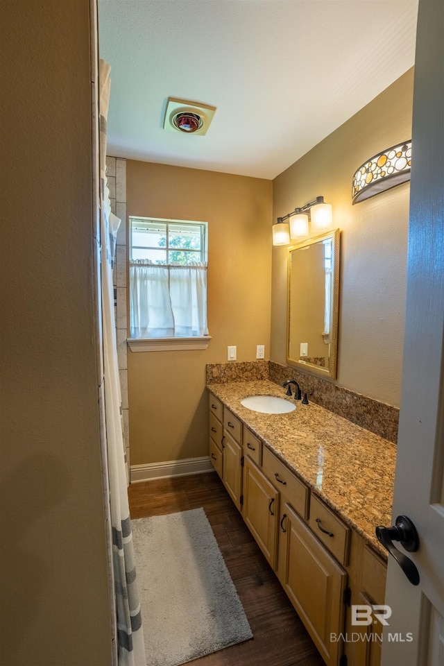 9150 County Road 91, Lillian, AL 36549 - bathroom featuring wood finished floors, vanity, and baseboards