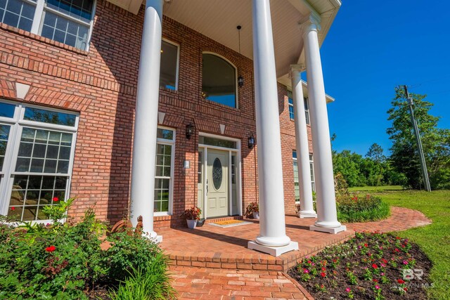9150 County Road 91, Lillian, AL 36549 - view of exterior entry featuring covered porch and brick siding