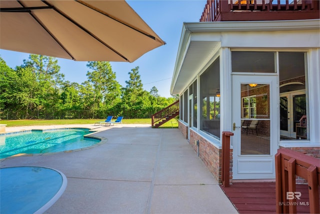 9150 County Road 91, Lillian, AL 36549 - view of pool featuring a sunroom, a patio, and view of wooded area