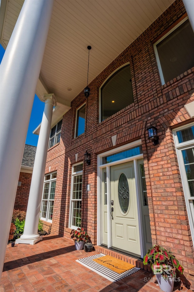 9150 County Road 91, Lillian, AL 36549 - view of exterior entry with brick siding and a porch