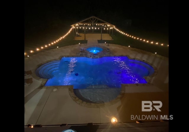 9150 County Road 91, Lillian, AL 36549 - pool at twilight with an in-ground hot tub