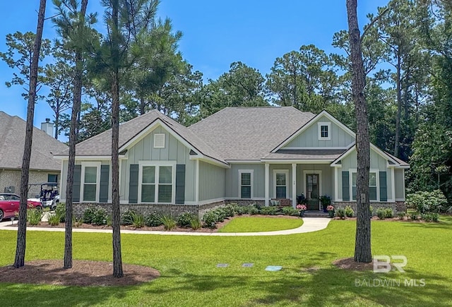 36 Haven Dr, Gulf Shores, AL 36542 - view of front of house featuring a front yard, board and batten siding, and roof with shingles