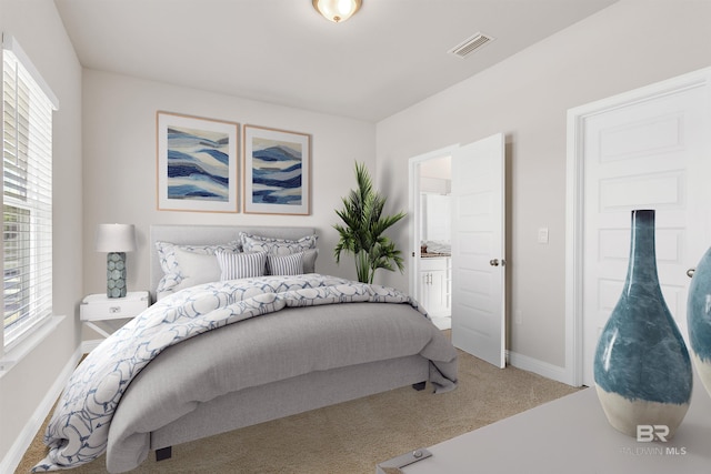 bedroom with carpet and ensuite bath