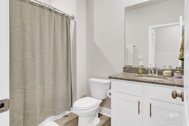 bathroom featuring vanity, hardwood / wood-style flooring, and toilet