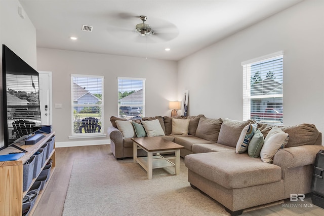 living room with hardwood / wood-style floors and ceiling fan