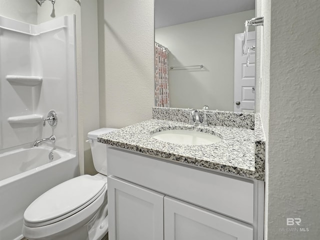 bathroom with toilet, a textured wall, shower / tub combo, and vanity