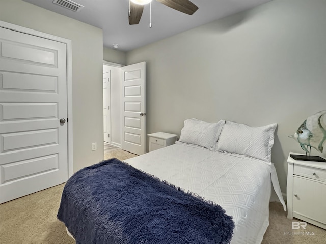 bedroom with baseboards, light carpet, a ceiling fan, and visible vents