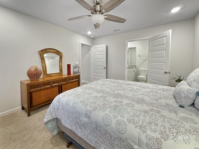 bedroom with ensuite bath, visible vents, baseboards, light carpet, and recessed lighting