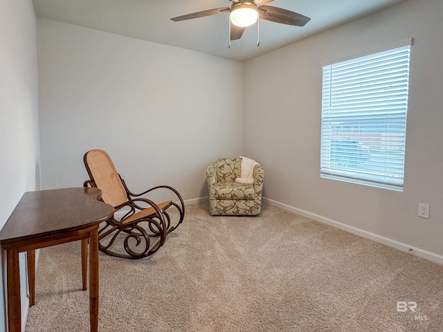 sitting room with carpet floors, baseboards, and ceiling fan