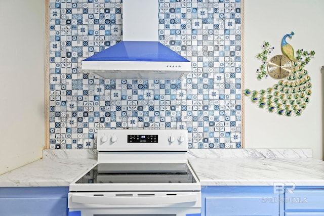 kitchen with light stone counters, electric range, backsplash, and exhaust hood