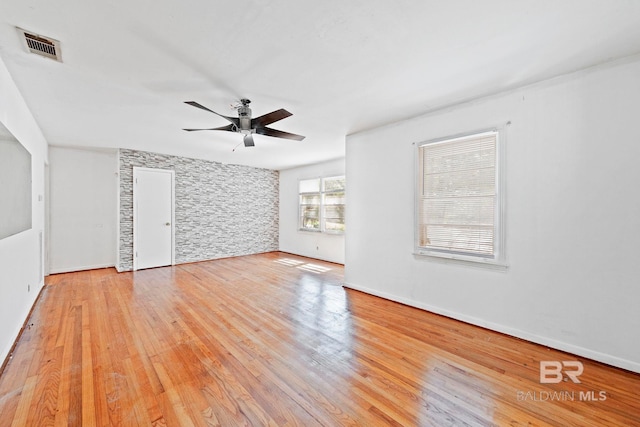 empty room featuring light hardwood / wood-style flooring and ceiling fan