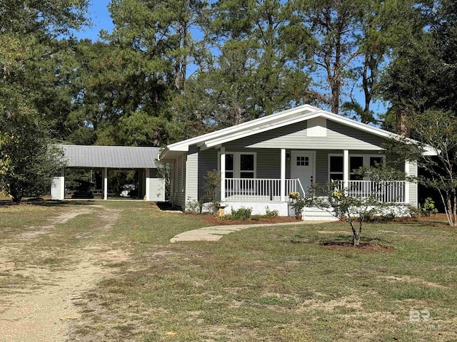 7121 N Century Blvd, Century, FL 32535 - view of front of house featuring covered porch, a front lawn, and dirt driveway