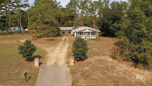 7121 N Century Blvd, Century, FL 32535 - view of front facade featuring dirt driveway and covered porch