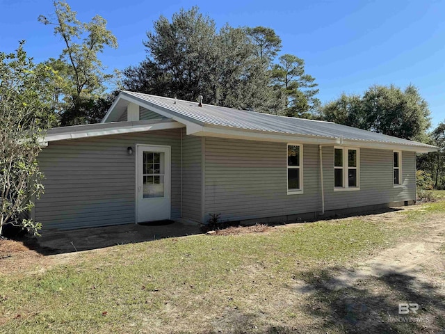 7121 N Century Blvd, Century, FL 32535 - view of side of property featuring metal roof and a lawn