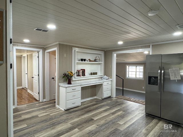 7121 N Century Blvd, Century, FL 32535 - kitchen with stainless steel fridge with ice dispenser, dark wood-style floors, white cabinetry, ornamental molding, and light countertops