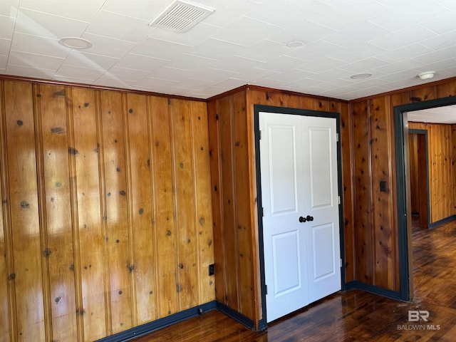 7121 N Century Blvd, Century, FL 32535 - empty room featuring dark wood-style flooring, wood walls, a smoke detector, and baseboards