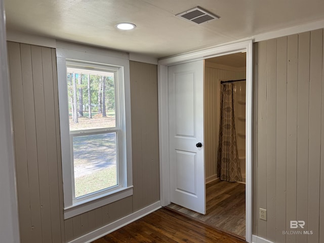 7121 N Century Blvd, Century, FL 32535 - unfurnished bedroom featuring dark wood-type flooring and wood walls