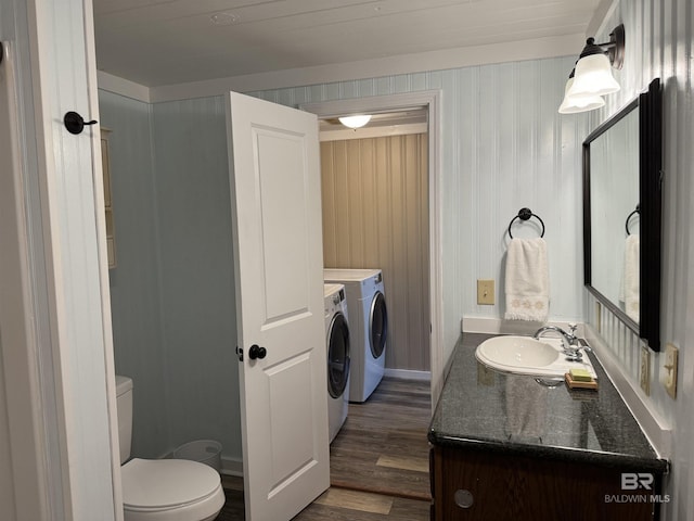 7121 N Century Blvd, Century, FL 32535 - bathroom with washing machine and clothes dryer, vanity, toilet, and wood finished floors