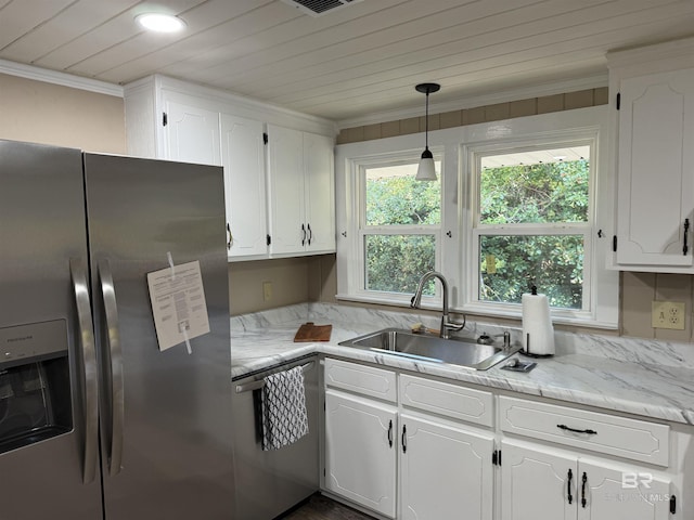 7121 N Century Blvd, Century, FL 32535 - kitchen with stainless steel appliances, a sink, white cabinetry, ornamental molding, and decorative light fixtures
