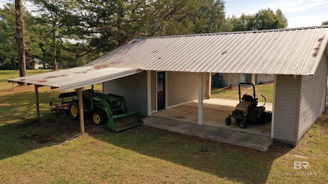 7121 N Century Blvd, Century, FL 32535 - rear view of property with a carport, a lawn, metal roof, and a patio
