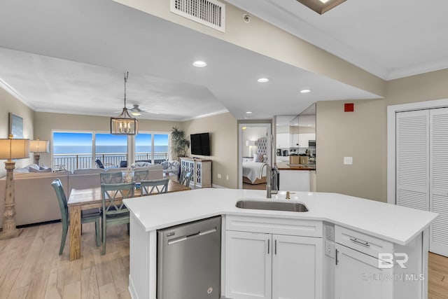 26200 Perdido Beach Blvd Unit 1403, Orange Beach, AL 36561 - kitchen featuring open floor plan, stainless steel dishwasher, crown molding, light countertops, and light wood-type flooring