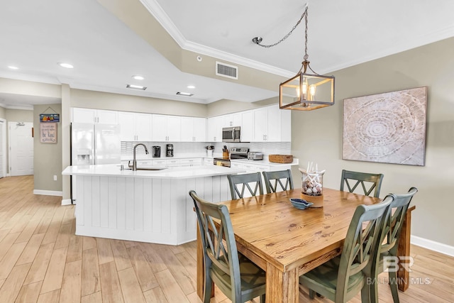 26200 Perdido Beach Blvd Unit 1403, Orange Beach, AL 36561 - dining space featuring crown molding, light wood-style floors, a chandelier, and recessed lighting