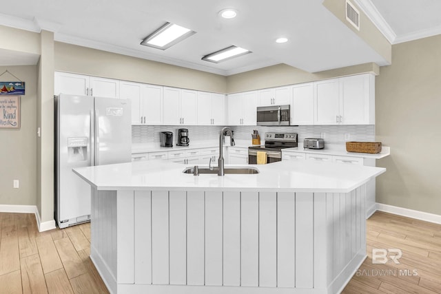 26200 Perdido Beach Blvd Unit 1403, Orange Beach, AL 36561 - kitchen with stainless steel appliances, crown molding, light wood-type flooring, tasteful backsplash, and white cabinetry