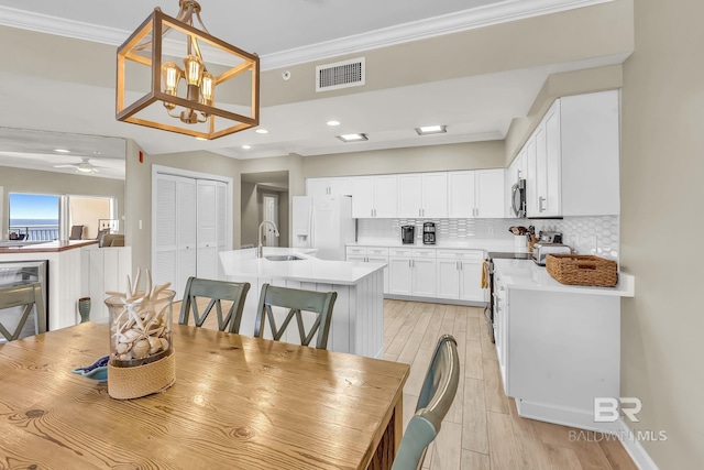 26200 Perdido Beach Blvd Unit 1403, Orange Beach, AL 36561 - dining room with ornamental molding, light wood-style floors, a ceiling fan, recessed lighting, and a chandelier