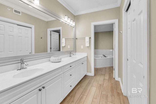 26200 Perdido Beach Blvd Unit 1403, Orange Beach, AL 36561 - bathroom with double vanity, wood finished floors, a bath, and ornamental molding