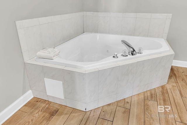 26200 Perdido Beach Blvd Unit 1403, Orange Beach, AL 36561 - bathroom featuring a whirlpool tub and wood finished floors