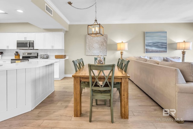 26200 Perdido Beach Blvd Unit 1403, Orange Beach, AL 36561 - dining room with ornamental molding, light wood-style flooring, and recessed lighting