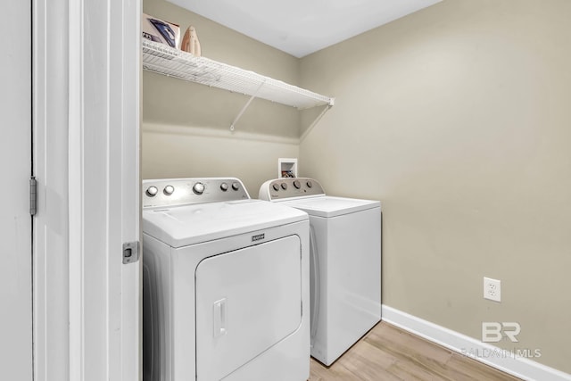 26200 Perdido Beach Blvd Unit 1403, Orange Beach, AL 36561 - washroom with separate washer and dryer and light wood-style flooring